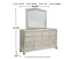Coralayne Queen Upholstered Bed with Mirrored Dresser